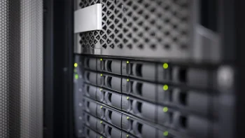 oblique perspective on a network storage device with many hard drives and lit status leds oblique perspective on a network storage device with many hard drives and lit status leds